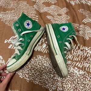 Worn green high top converse